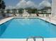 Large community pool with lounge seating and well-maintained white fences with surrounding condominium complex at 1919 Spring St. # B12, North Myrtle Beach, SC 29582