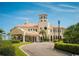 The exterior of a luxurious building with a tower, pillars, and manicured landscaping at 219 Atlantic Breeze St., Myrtle Beach, SC 29572