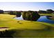 Aerial view of a lush green golf course with a pond and golfers walking the fairway at 219 Atlantic Breeze St., Myrtle Beach, SC 29572