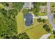 Aerial view of a luxury home featuring a dark roof, large yard, surrounded by lush trees at 2192 Eastwoods Dr., Conway, SC 29526