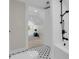 Bathroom showcasing black fixtures, white tiling and classic mosaic tile flooring leading to the bedroom at 2192 Eastwoods Dr., Conway, SC 29526