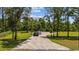 Long gravel driveway leading to a house surrounded by trees, highlighting the home's secluded location at 2192 Eastwoods Dr., Conway, SC 29526
