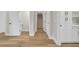 Hallway features hardwood floors, neutral paint, and multiple doorways leading to different areas of the home at 2192 Eastwoods Dr., Conway, SC 29526