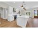 Bright kitchen featuring a large island, stainless steel appliances, and wooden floors at 2192 Eastwoods Dr., Conway, SC 29526