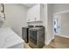 Laundry room with high end washer and dryer machines, stone countertops and overhead cabinets at 2192 Eastwoods Dr., Conway, SC 29526