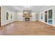 Bright living room featuring a fireplace, wooden floors, and sliding glass doors at 2192 Eastwoods Dr., Conway, SC 29526