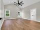Spacious main bedroom features hardwood floors, natural light, and an ensuite bathroom with tile flooring at 2192 Eastwoods Dr., Conway, SC 29526