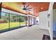 Open patio with a wood-paneled ceiling, ceiling fan, and expansive screened windows overlooking the yard at 2192 Eastwoods Dr., Conway, SC 29526