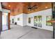 Covered outdoor patio with wood ceiling, fan, sliding doors, and a view of the green backyard at 2192 Eastwoods Dr., Conway, SC 29526