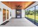 Relaxing outdoor patio featuring a fireplace with mounted TV, ceiling fan, and views of the backyard at 2192 Eastwoods Dr., Conway, SC 29526