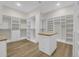 Large walk-in closet with custom shelving, ample storage space, and a center island with butcher block top at 2192 Eastwoods Dr., Conway, SC 29526