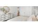 Bright bedroom with white dresser, mirror and decor with a peak into kitchen at 222 Atlantic Breeze St., Myrtle Beach, SC 29572