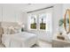Bright bedroom with white decor, plush bedding, and natural light at 222 Atlantic Breeze St., Myrtle Beach, SC 29572