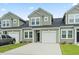 Charming townhome with a one car garage, black front door and muted green siding at 244 Jasper Overlook Way # 244, Myrtle Beach, SC 29588