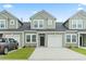 Charming townhome with a one car garage, black front door and muted green siding at 244 Jasper Overlook Way # 244, Myrtle Beach, SC 29588