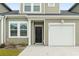 Welcoming front door of a charming townhome with a one car garage and muted green siding at 244 Jasper Overlook Way # 244, Myrtle Beach, SC 29588
