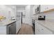 Bright open concept kitchen with white cabinets, stainless appliances, and hardwood floors at 244 Jasper Overlook Way # 244, Myrtle Beach, SC 29588