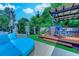 Backyard patio with a deck, an outdoor sofa, and some grass with a privacy fence at 2479 Burning Tree Ln., Little River, SC 29566