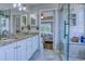 Bathroom featuring white cabinets, granite countertops, and a glass door shower at 2479 Burning Tree Ln., Little River, SC 29566