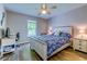 Bedroom with hardwood floors, light gray walls, a ceiling fan, and an office area at 2479 Burning Tree Ln., Little River, SC 29566