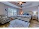 Bedroom with a patterned chair, hard floors, shuttered window, and nautical decor at 2479 Burning Tree Ln., Little River, SC 29566