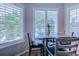 Bright breakfast nook with wood floors, four chairs, large windows and charming plantation shutters at 2479 Burning Tree Ln., Little River, SC 29566
