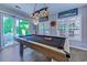 Game room with a wood pool table, stylish lighting, and access to a charming outdoor area at 2479 Burning Tree Ln., Little River, SC 29566