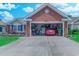 Attached garage with tools, a red car, and overhead storage at 2479 Burning Tree Ln., Little River, SC 29566