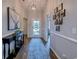 Welcoming hallway features hardwood floors, a decorative rug, stylish lighting, and elegant wall decor at 2479 Burning Tree Ln., Little River, SC 29566