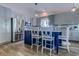 Modern kitchen features stainless steel appliances, a kitchen island with bar stools, and ample cabinet space at 2479 Burning Tree Ln., Little River, SC 29566