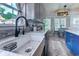 Modern kitchen featuring stainless steel appliances, granite countertops, gray cabinetry, and a farmhouse sink at 2479 Burning Tree Ln., Little River, SC 29566