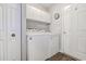Bright laundry room featuring a washer, dryer, laminate floors, and overhead cabinets at 2479 Burning Tree Ln., Little River, SC 29566