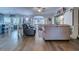 Open-concept living room with hardwood floors, neutral paint, ceiling fan, and plenty of natural light at 2479 Burning Tree Ln., Little River, SC 29566