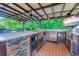 Outdoor kitchen with a bar and an under-counter refrigerator and ice maker at 2479 Burning Tree Ln., Little River, SC 29566