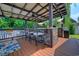 Outdoor kitchen with bar, television, and barstool seating at 2479 Burning Tree Ln., Little River, SC 29566