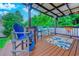 Outdoor kitchen and bar area with seating, rug, and backyard view at 2479 Burning Tree Ln., Little River, SC 29566
