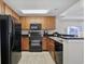 Kitchen features black appliances, wood cabinets and granite countertops at 2600 N Ocean Blvd. # 1914, Myrtle Beach, SC 29577