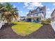 Expansive backyard featuring lush green lawn and well-maintained landscaping at 302 46Th Ave. N, North Myrtle Beach, SC 29582