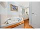 A bathroom with a jacuzzi tub and hardwood flooring at 302 46Th Ave. N, North Myrtle Beach, SC 29582