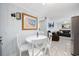 Dining area with white table and chairs, adjacent to the living area at 302 46Th Ave. N, North Myrtle Beach, SC 29582