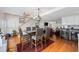 Open concept dining room boasts wood floors, a glass top table with seating for six, and staircase at 302 46Th Ave. N, North Myrtle Beach, SC 29582