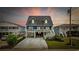 Charming stilted home with a spacious driveway, elevated deck, and lovely architectural details at 302 46Th Ave. N, North Myrtle Beach, SC 29582