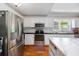 Bright kitchen features white cabinets, stainless steel appliances, and an island at 302 46Th Ave. N, North Myrtle Beach, SC 29582