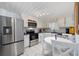 Eat-in kitchen featuring white cabinets, stainless steel appliances, and tile flooring at 302 46Th Ave. N, North Myrtle Beach, SC 29582