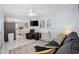 Cozy living area featuring a comfortable sofa, television, and white tile flooring at 302 46Th Ave. N, North Myrtle Beach, SC 29582