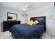 Cozy bedroom features neutral walls, a ceiling fan, and a dark wood dresser at 302 46Th Ave. N, North Myrtle Beach, SC 29582