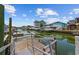 Waterfront view showcasing the dock and beautiful homes along the canal on a sunny day with blue sky at 302 46Th Ave. N, North Myrtle Beach, SC 29582