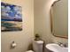 Powder room featuring beach themed painting and stylish mirror at 312 Shelly Bay Ct., Surfside Beach, SC 29575