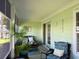 Relaxing screened-in porch featuring comfortable seating and green accents at 312 Shelly Bay Ct., Surfside Beach, SC 29575