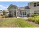 Backyard patio with seating area and view of the green space at 315 Bulkhead Bend # 315, Carolina Shores, NC 28467